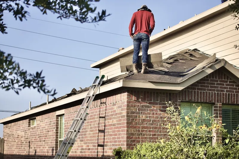 Professional roofer working on a residential roof in Tarrant